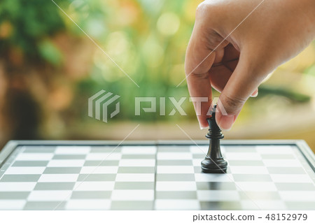 Businessman holding a King Chess is placed on Businessman holding a King Chess is placed on 48152979
