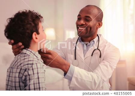 Careful doctor providing the examination of child throat 48155005