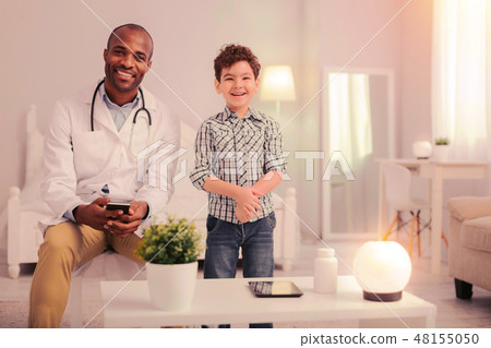 Kid and a doctor sitting in the room Kid and a doctor sitting in the room 48155050