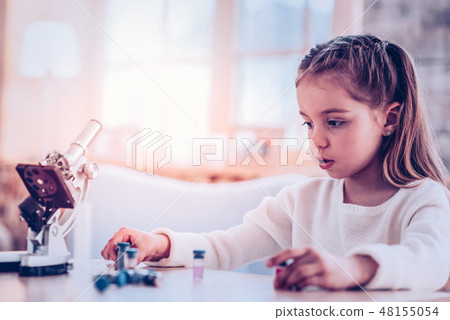 Concentrated kid teaching new biology colorful elements Concentrated kid teaching new biology colorful elements 48155054