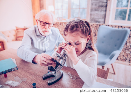 Personal teacher explaining how watching in microscope Personal teacher explaining how watching in microscope 48155066