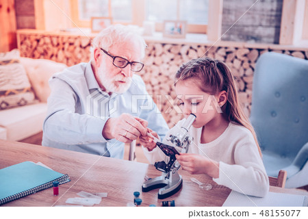 Teacher of Biology showing how using lens from microscope Teacher of Biology showing how using lens from microscope 48155077