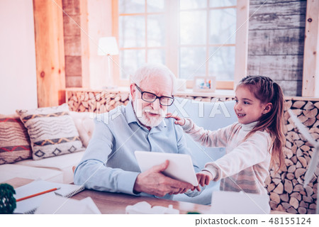 Preschooler explaining elderly man how searching the Internet Preschooler explaining elderly man how searching the Internet 48155124