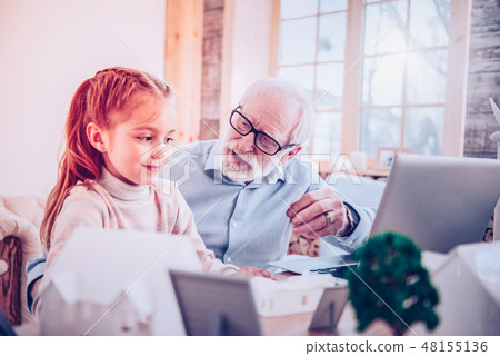 Grandpa explaining homework his granddaughter at home Grandpa explaining homework his granddaughter at home 48155136