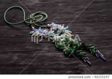 The stones collected on ropes in the form of beads The stones collected on ropes in the form of beads 48155247