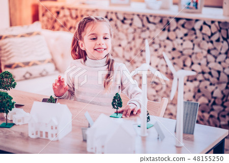 Young woman building toy town for the school Young woman building toy town for the school 48155250