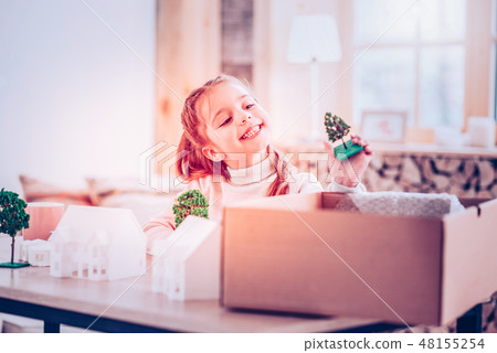 Cheerful girl playing with toys alone at house Cheerful girl playing with toys alone at house 48155254