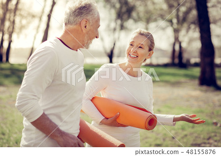 Cheerful senior people talking while walking outdoors 48155876