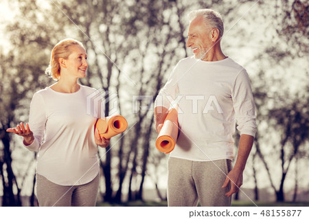 Positive delighted couple walking together in park 48155877