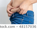 woman touching his fat belly has overweight 48157036