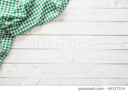 Green checkered kitchen tablecloth on wooden table 48157314