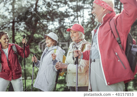 Large company from elderly people and young lady talking with each other 48157853