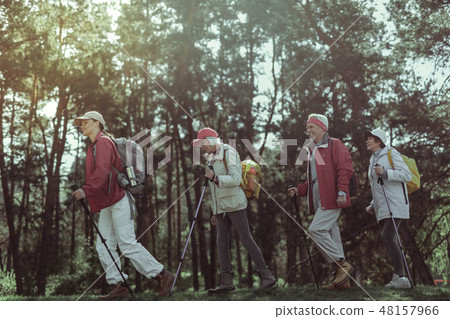 Amateur tourists enjoying one day hike in the forest 48157966