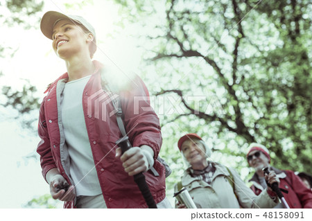 Young hiking guide feeling inspired by elderly tourists 48158091