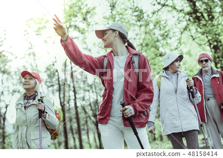 Woman shoving natural reserve to the group of seniors 48158414