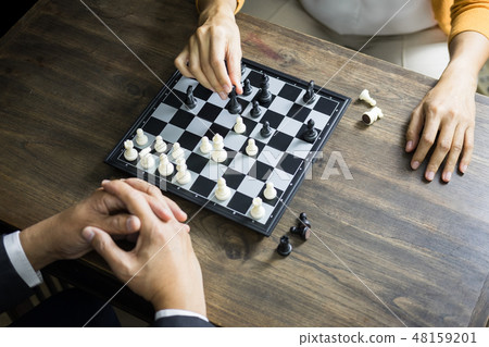hand of businessman moving chess figure in competition board gam hand of businessman moving chess figure in competition board gam 48159201