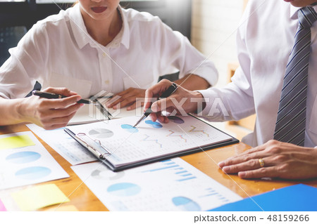 Business team data analyzing income charts document during discu 48159266