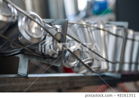 Conveyor for bottling beer in aluminum cans. Close up Conveyor for bottling beer in aluminum cans. Close up 48161351