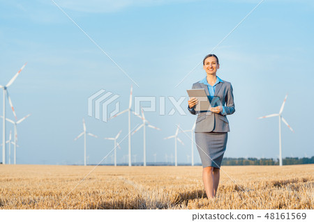 Women putting money into an ethical Investment of wind turbines Women putting money into an ethical Investment of wind turbines 48161569
