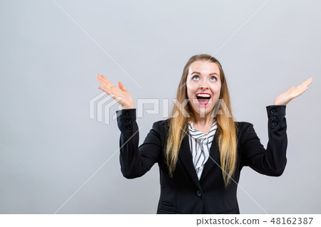 Young woman reaching and looking upwards 48162387