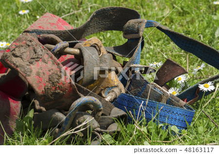 Muddy cave equipment on a green grass with daisies Muddy cave equipment on a green grass with daisies 48163117
