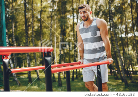 Sports man in a morning summer park  48163188