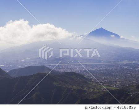 blue summit of volcano pico del teide highest spanish mountain in clouds with view on la orotava blue summit of volcano pico del teide highest spanish mountain in clouds with view on la orotava 48163859