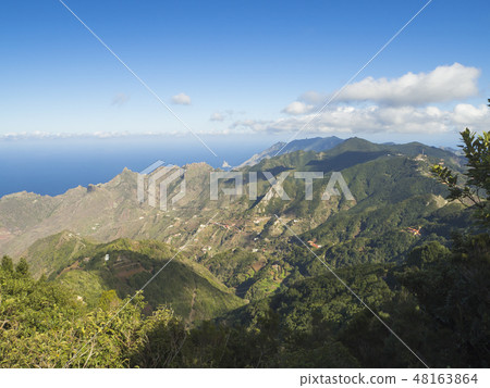 view point Amogoje, green hills with rock in the sea El Draguillo in anaga mountain, tenerife canary view point Amogoje, green hills with rock in the sea El Draguillo in anaga mountain, tenerife canary 48163864