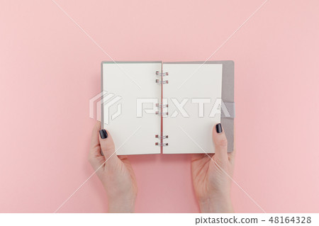 Woman hands with blank notepad mockup Woman hands with blank notepad mockup 48164328