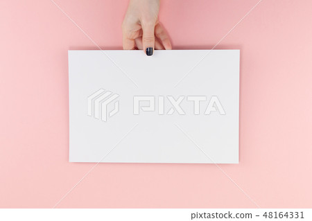 Woman hands with blank A4 paper sheet mockup Woman hands with blank A4 paper sheet mockup 48164331