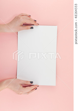 Woman hands with blank A4 paper sheet mockup 48164333