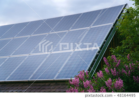 Solar panels on rood of modern resiadental house, renewable energy system. Solar panels on rood of modern resiadental house, renewable energy system. 48164495