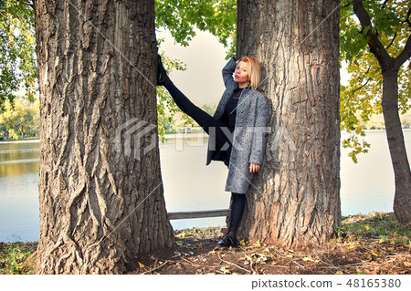 Beautiful girl standing between the trees with her legs high 48165380