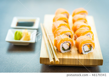 Salmon fish meat sushi roll maki on wood plate 48170341
