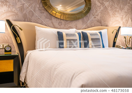 Comfotable pillow on bed with light lamp decoration Comfotable pillow on bed with light lamp decoration 48173038