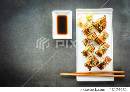 Grilled eel or unagi fish sushi maki roll with sweet sauce Grilled eel or unagi fish sushi maki roll with sweet sauce 48174081