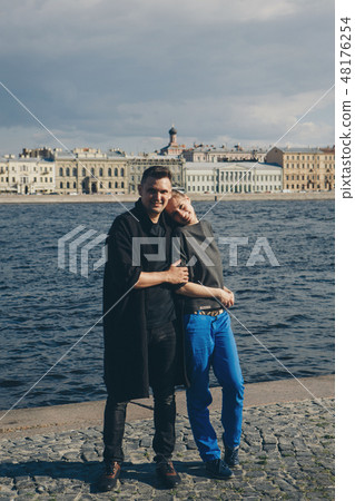 a man hugs a girl on background of the waterfront a man hugs a girl on background of the waterfront 48176254