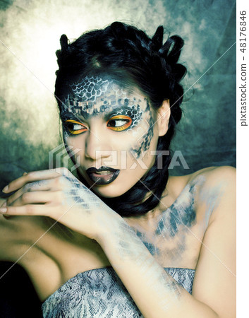 fashion portrait of pretty young woman with creative make up like a snake, halloween close up 48176846