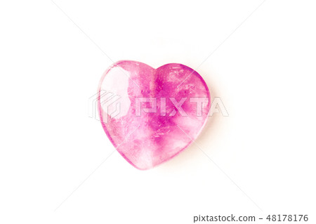 Overhead photo of a pink crystal heart on a white background with copy space 48178176