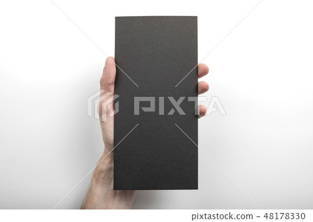 Mens hand holding black flyer 48178330