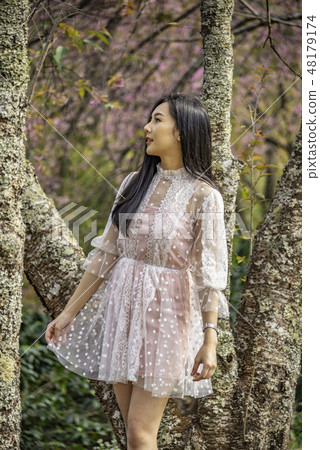 Beautiful young teenage girl posing under a trees. Beautiful young teenage girl posing under a trees. 48179174