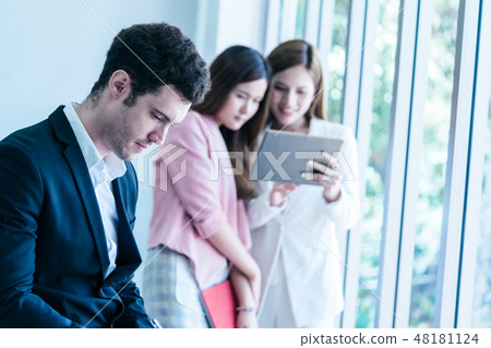 Lonely man in office lesbian couple in background Lonely man in office lesbian couple in background 48181124