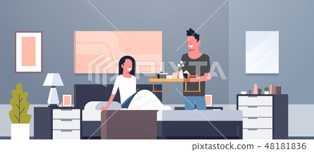 man bringing breakfast for his woman in bed happy 8 march womens day concept husband making surprise man bringing breakfast for his woman in bed happy 8 march womens day concept husband making surprise 48181836