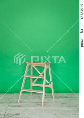 The working space of the photo studio with a green paper background and chair. The working space of the photo studio with a green paper background and chair. 48183015