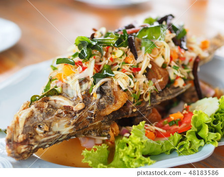 Fried fish with mixed herb on dish Fried fish with mixed herb on dish 48183586