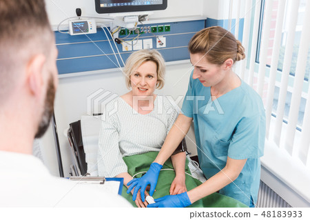 Patient in recovery room of hospital talking to doctor 48183933