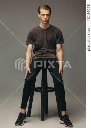 Confident and cheerful portrait handsome Caucasian male. Full body shot looking at camera standing Confident and cheerful portrait handsome Caucasian male. Full body shot looking at camera standing 48184068