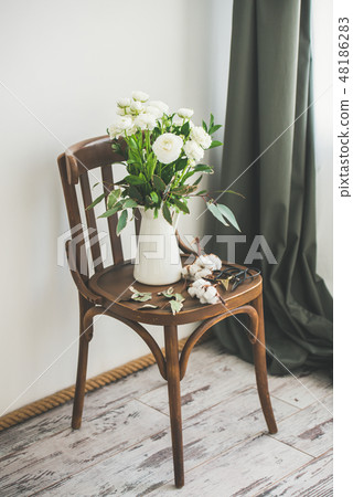 Spring white buttercup flowers in enamel jug on 48186283