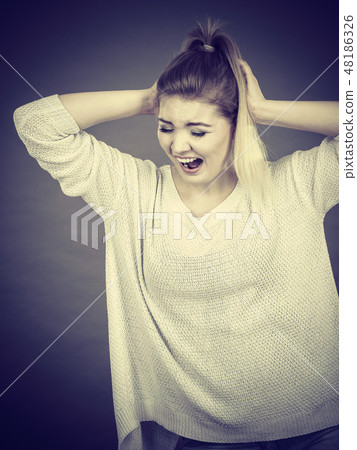 Unhappy woman screaming and yelling in pain Unhappy woman screaming and yelling in pain 48186326