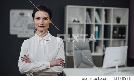Businesswoman standing, office interior on background, female. Businesswoman standing, office interior on background, female. 48188536